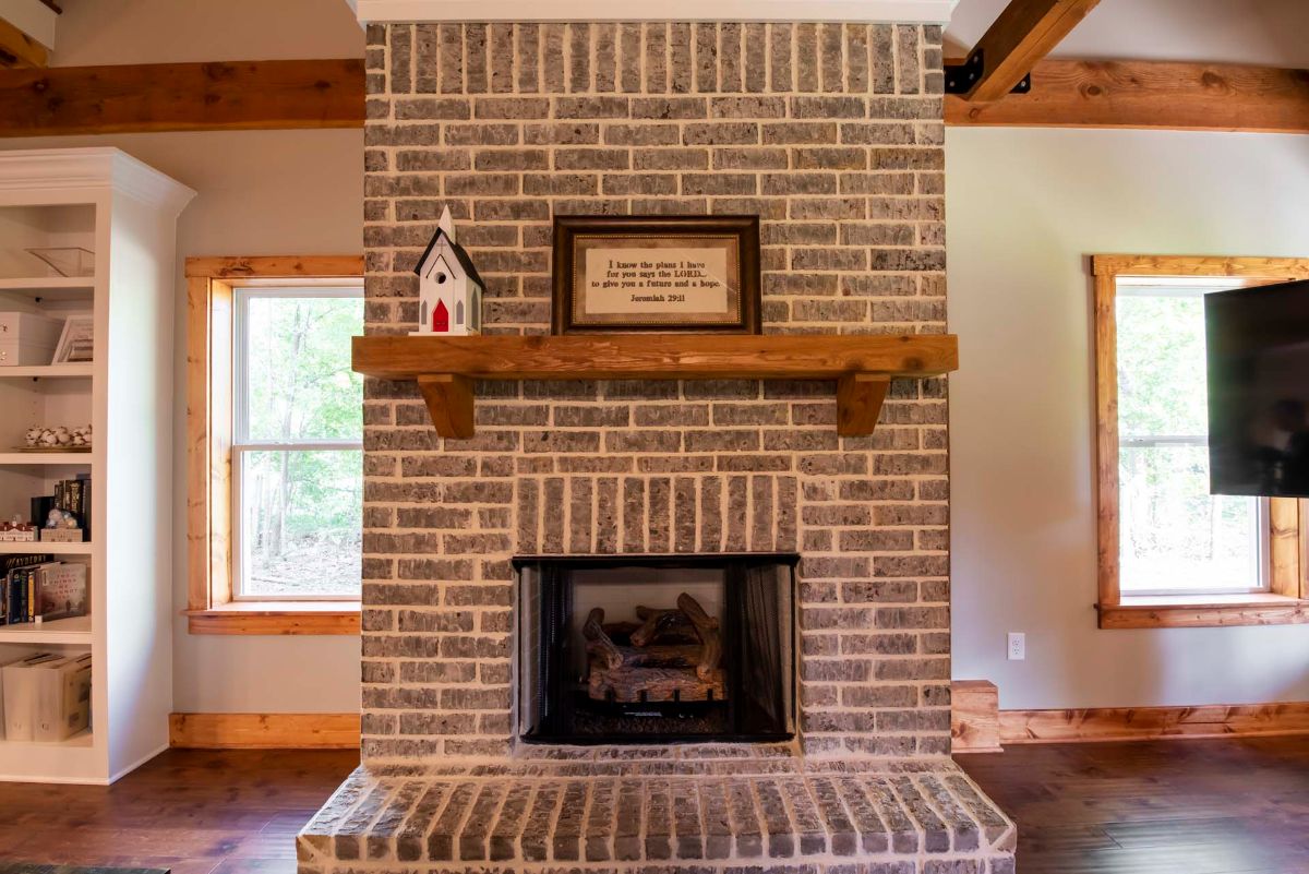 blonde brick fireplace against white wall