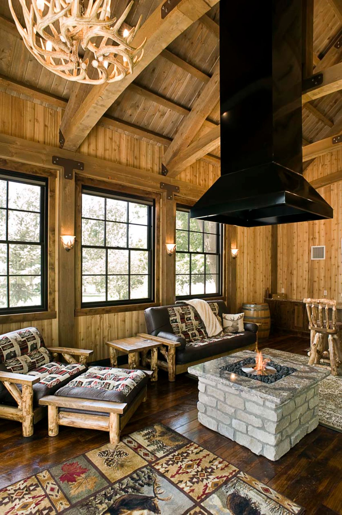 hanging vent hood in center of room over fire pit inside cabin