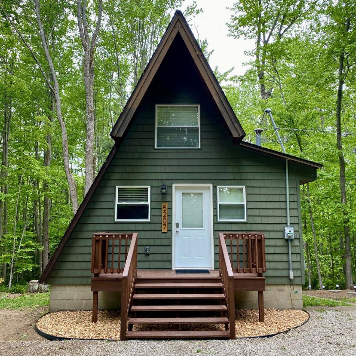 green aframe with dark wood porch