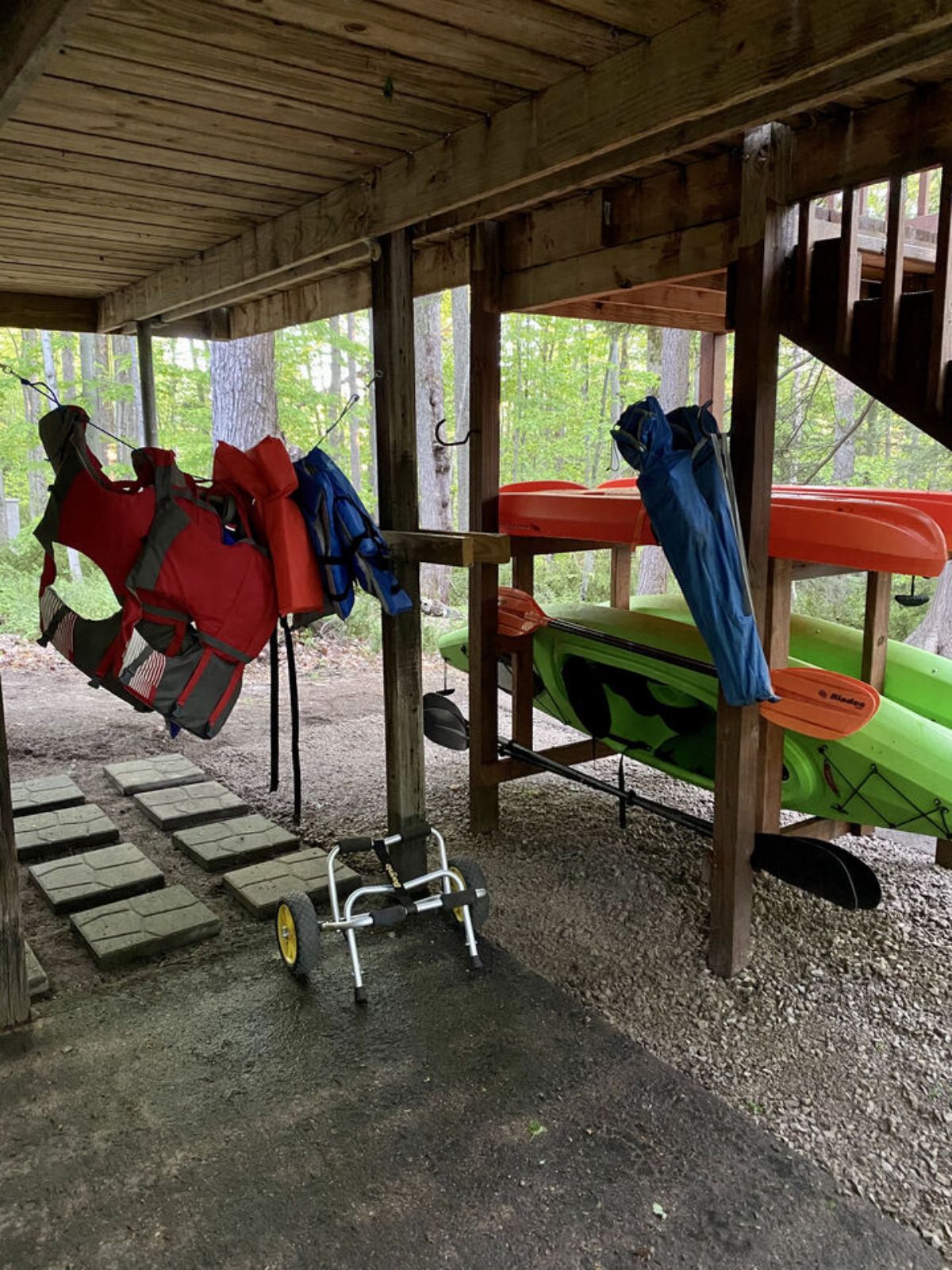 canoes and life vests hanging below side of cabin