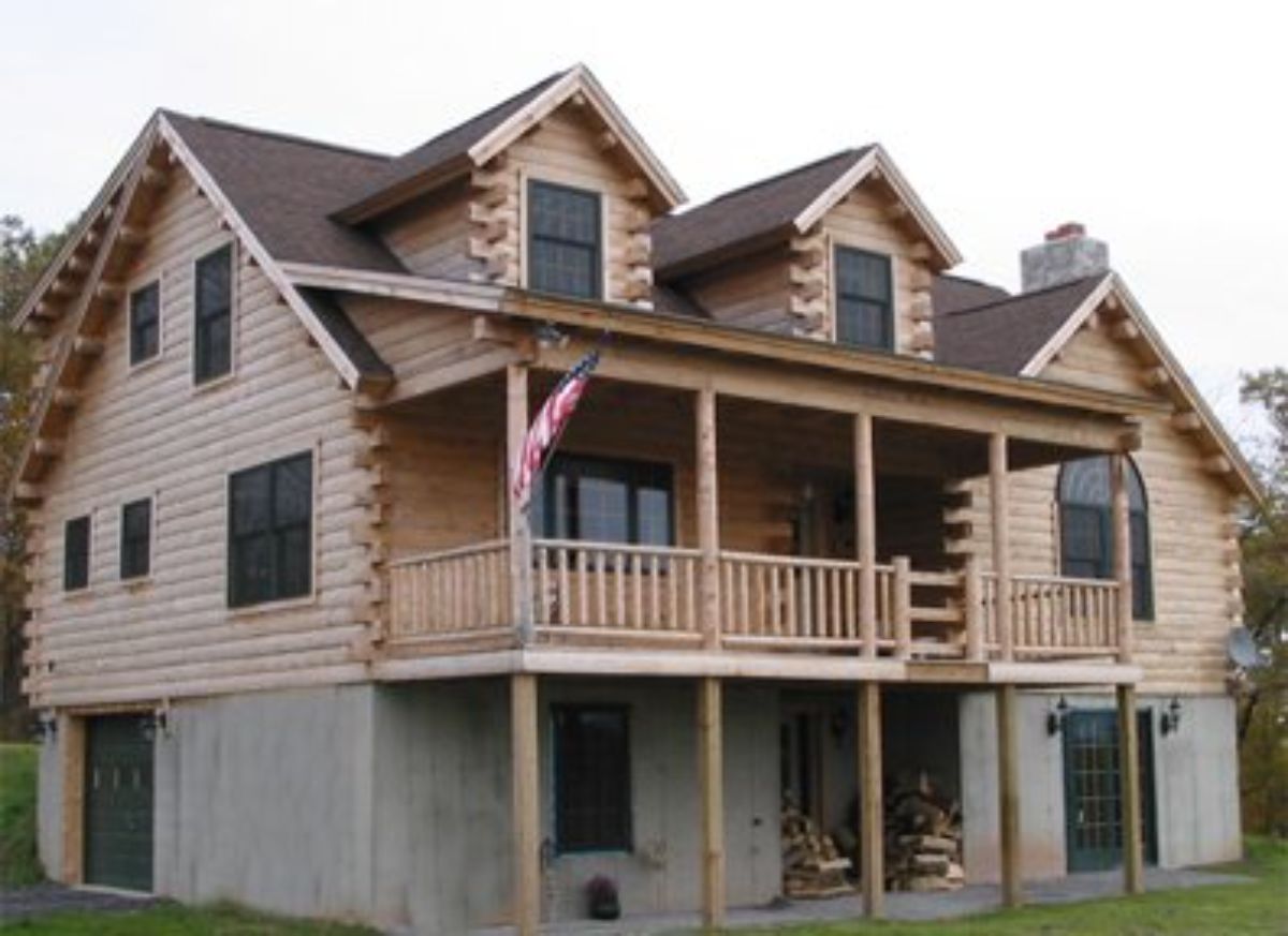 side and back of three level cabin with covered deck on back