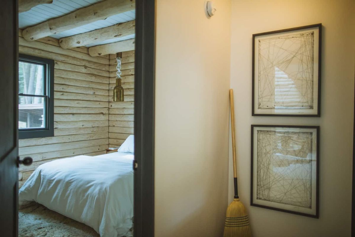 open door into bedroom with broom propped against wall beside the door