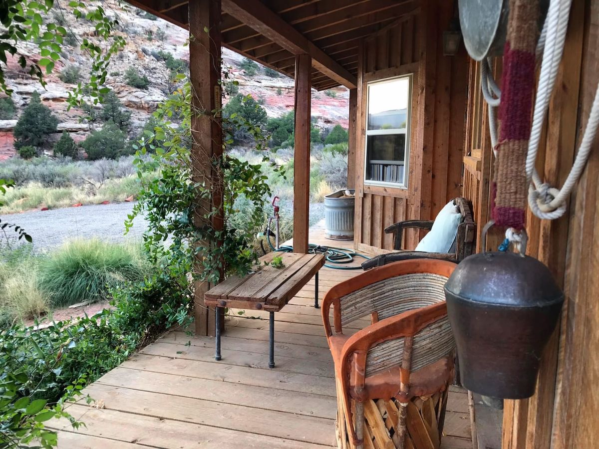 bench and wicker chairs on porch of cabin