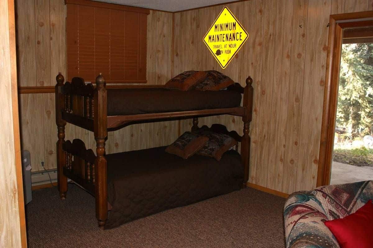 bunk beds against corner of paneled room