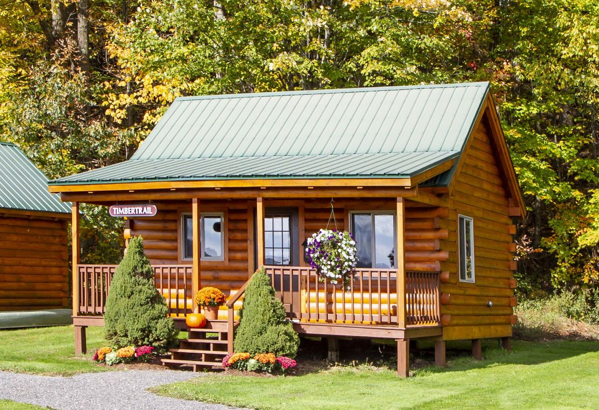 small cabin with shrubs on either side of front steps