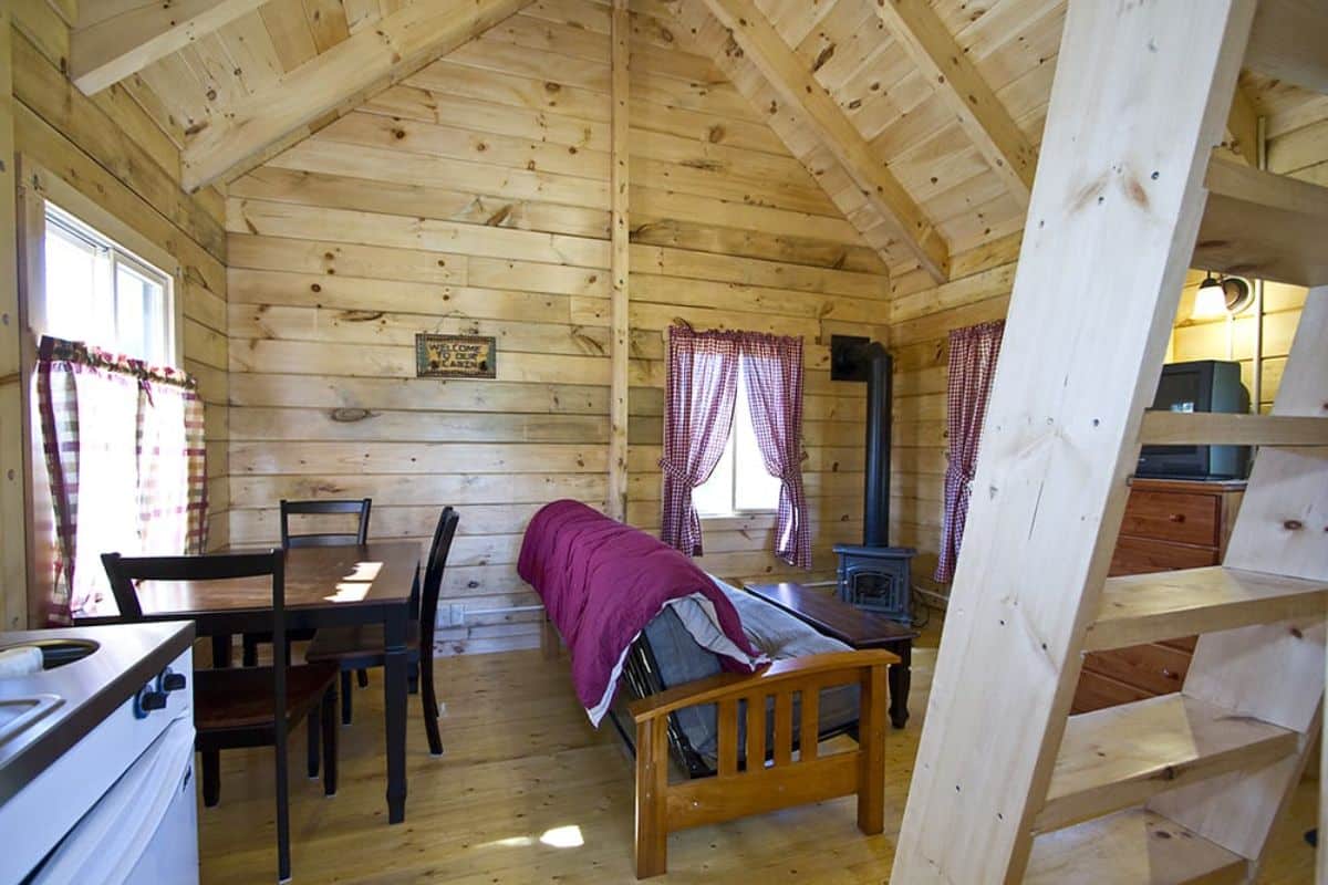 dining table on left with ladder to loft in foreground