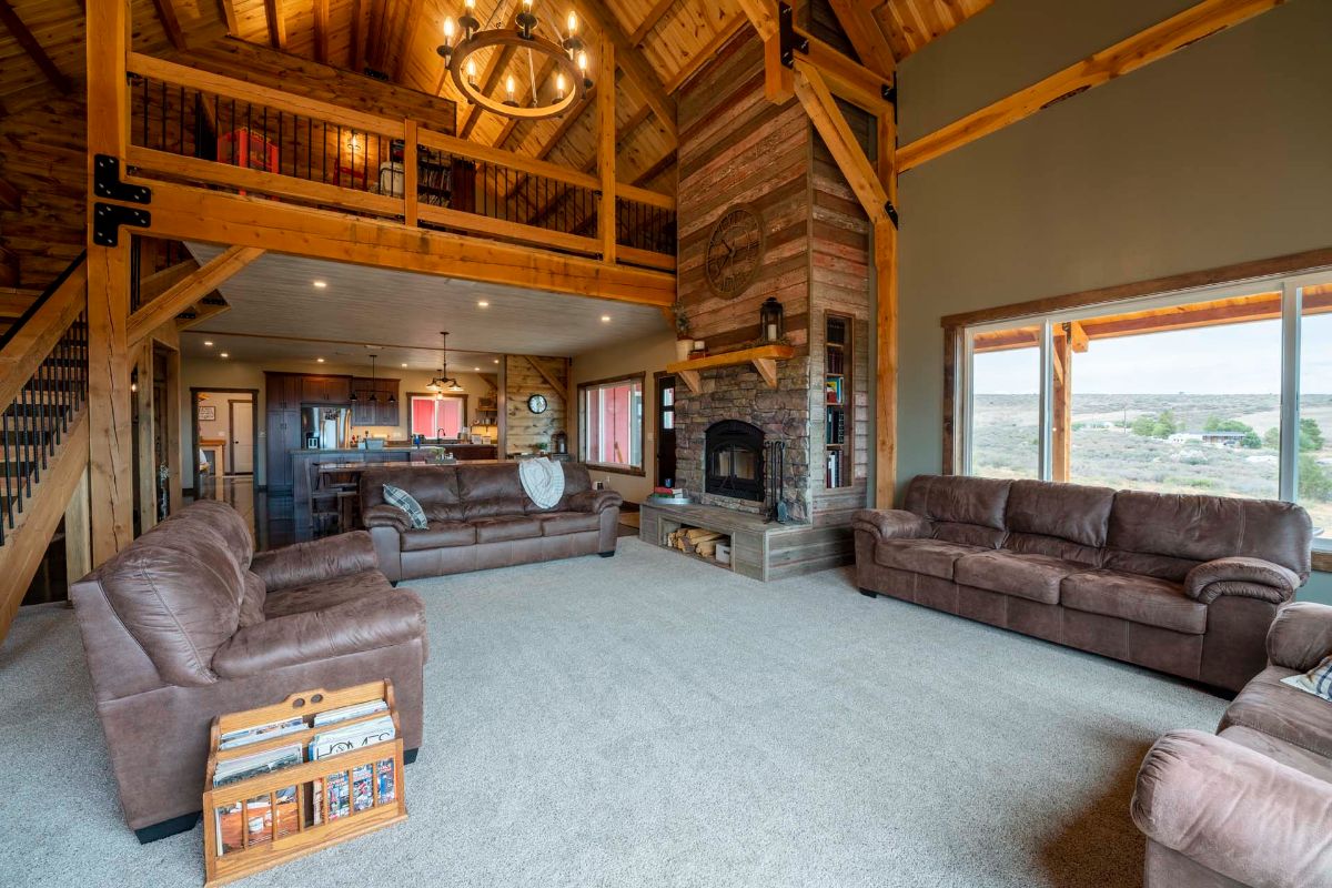 fireplace against far right wall in living room with brown leather furniture