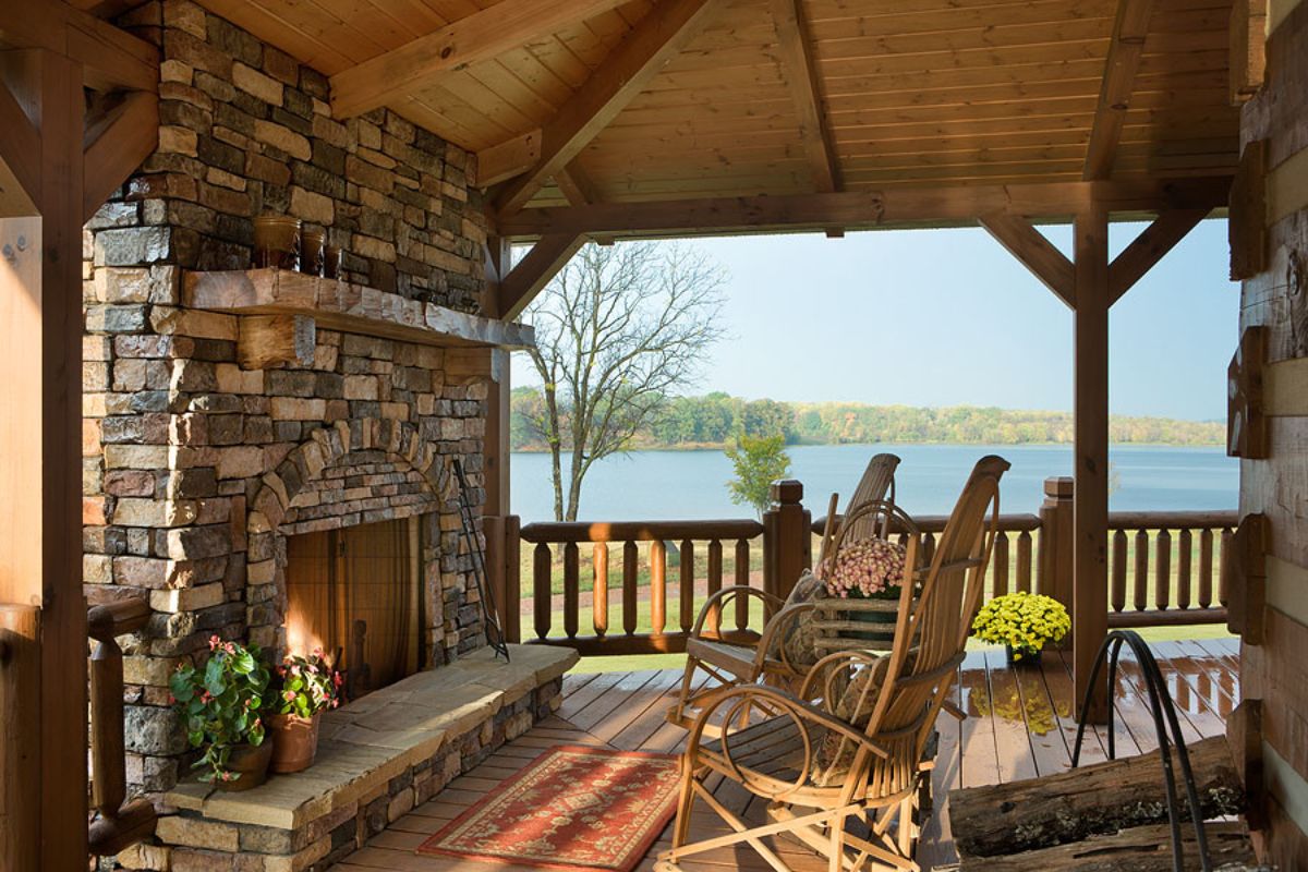 fireplace on left with rocking chairs on right of covered porch