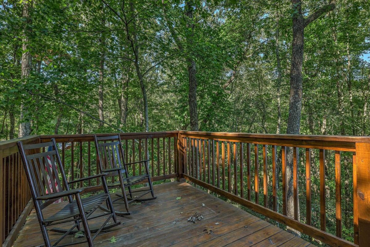 rocking chairs in corner of open porch on cabin