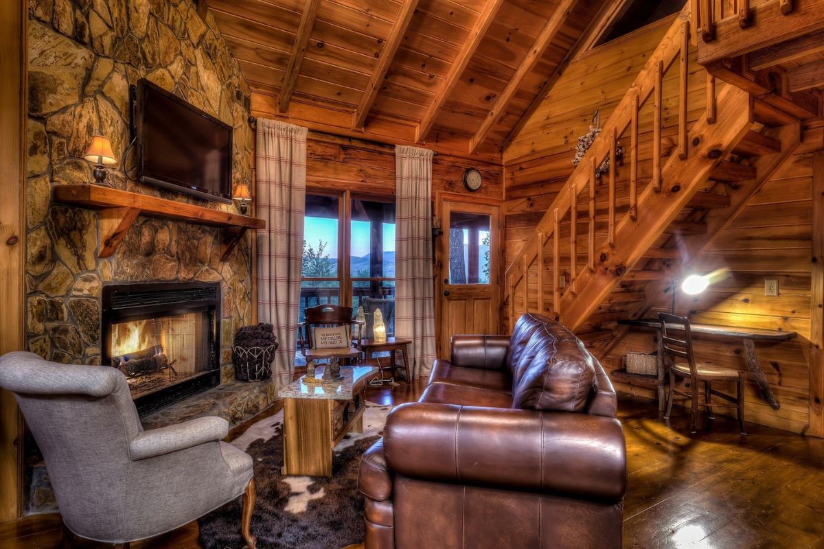 dark brown leather sofa in front of fireplace