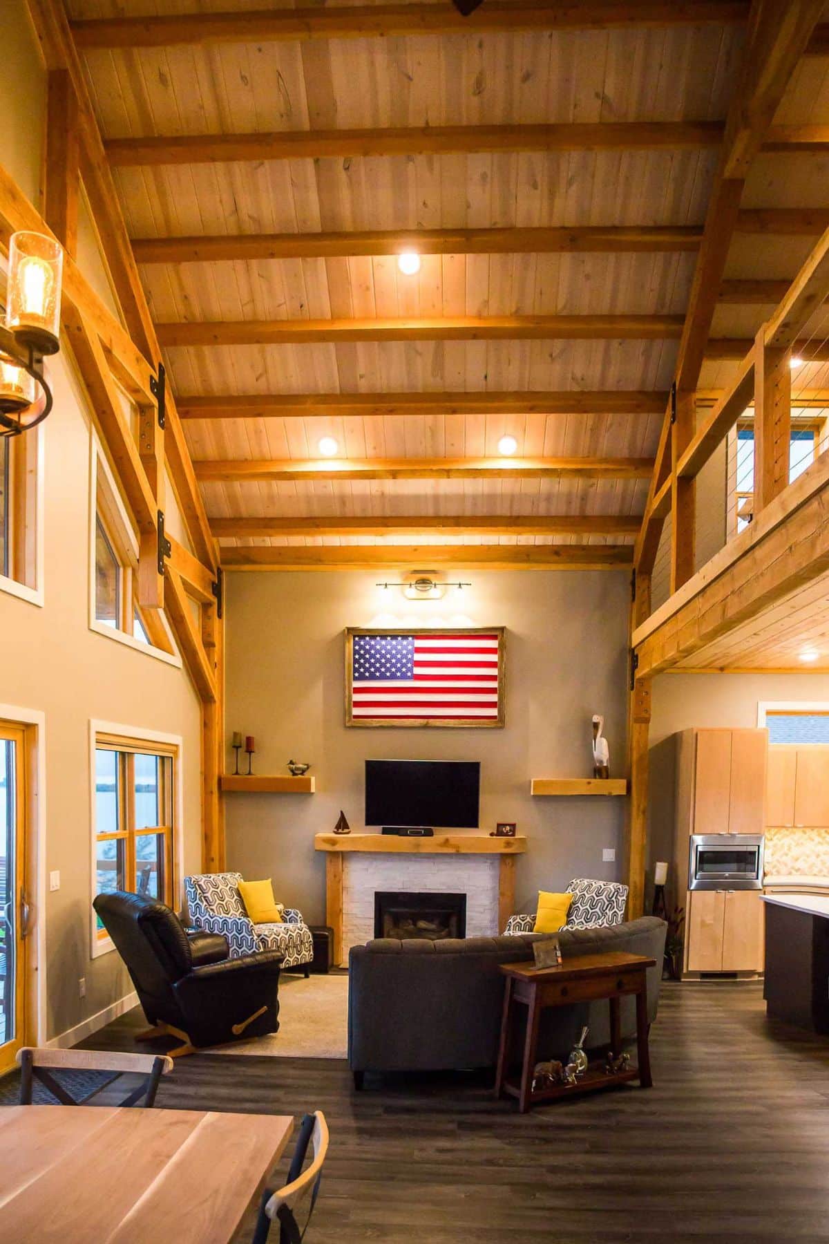 american flag displayed above fireplace in living room