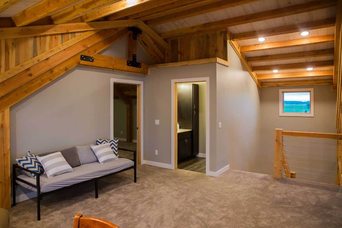 open loft with futon on left and stairs in background