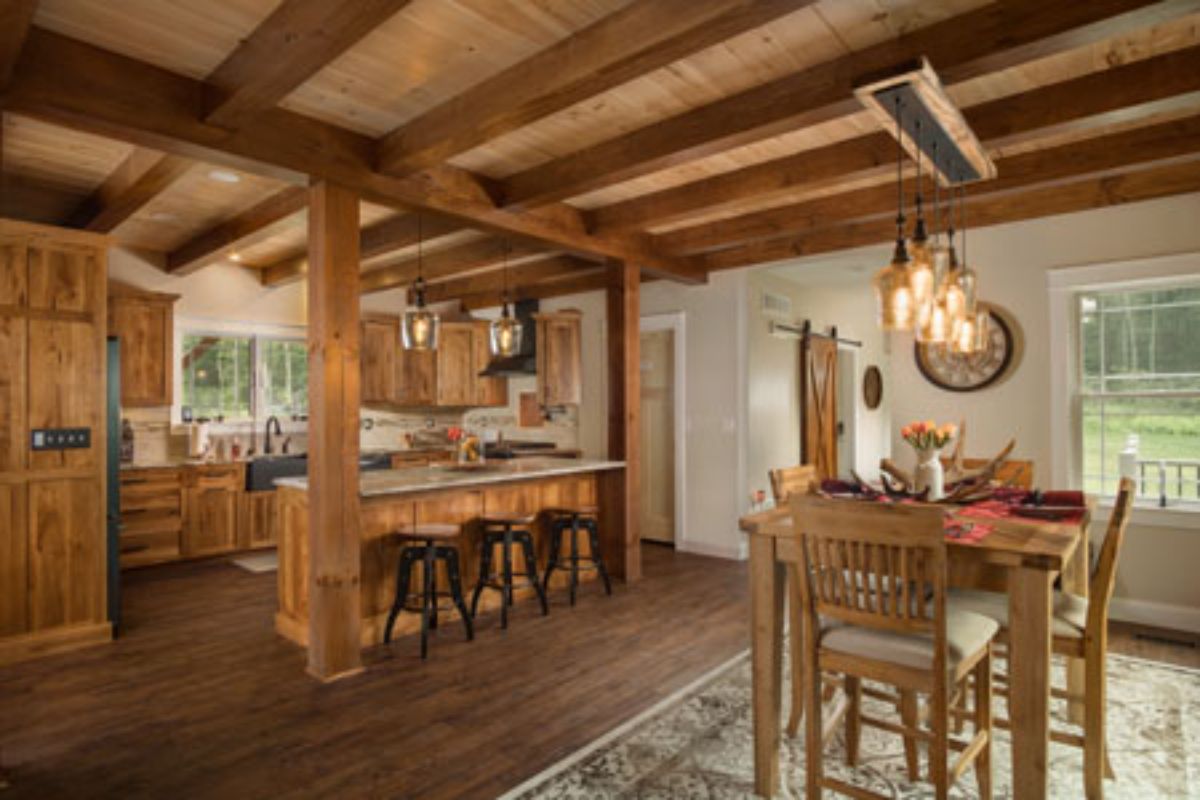 wooden bar with low back stools and dining table in foreground