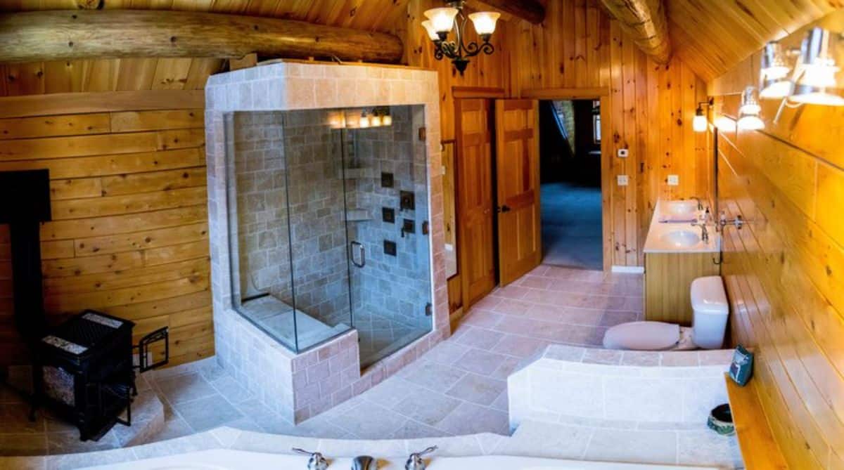 master bathroom with shower on left and bathtub in foreground