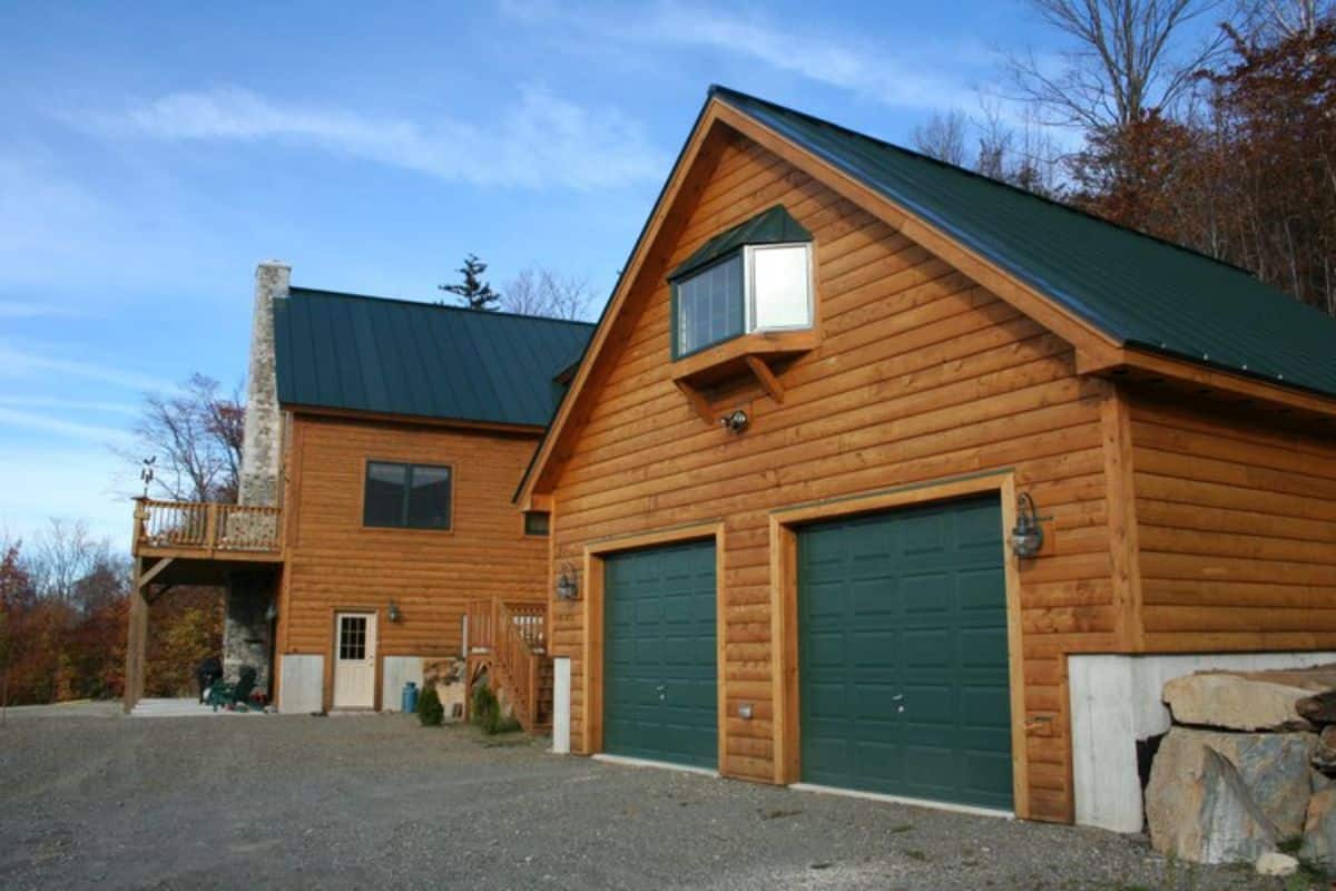 green garage doors on side of cabin