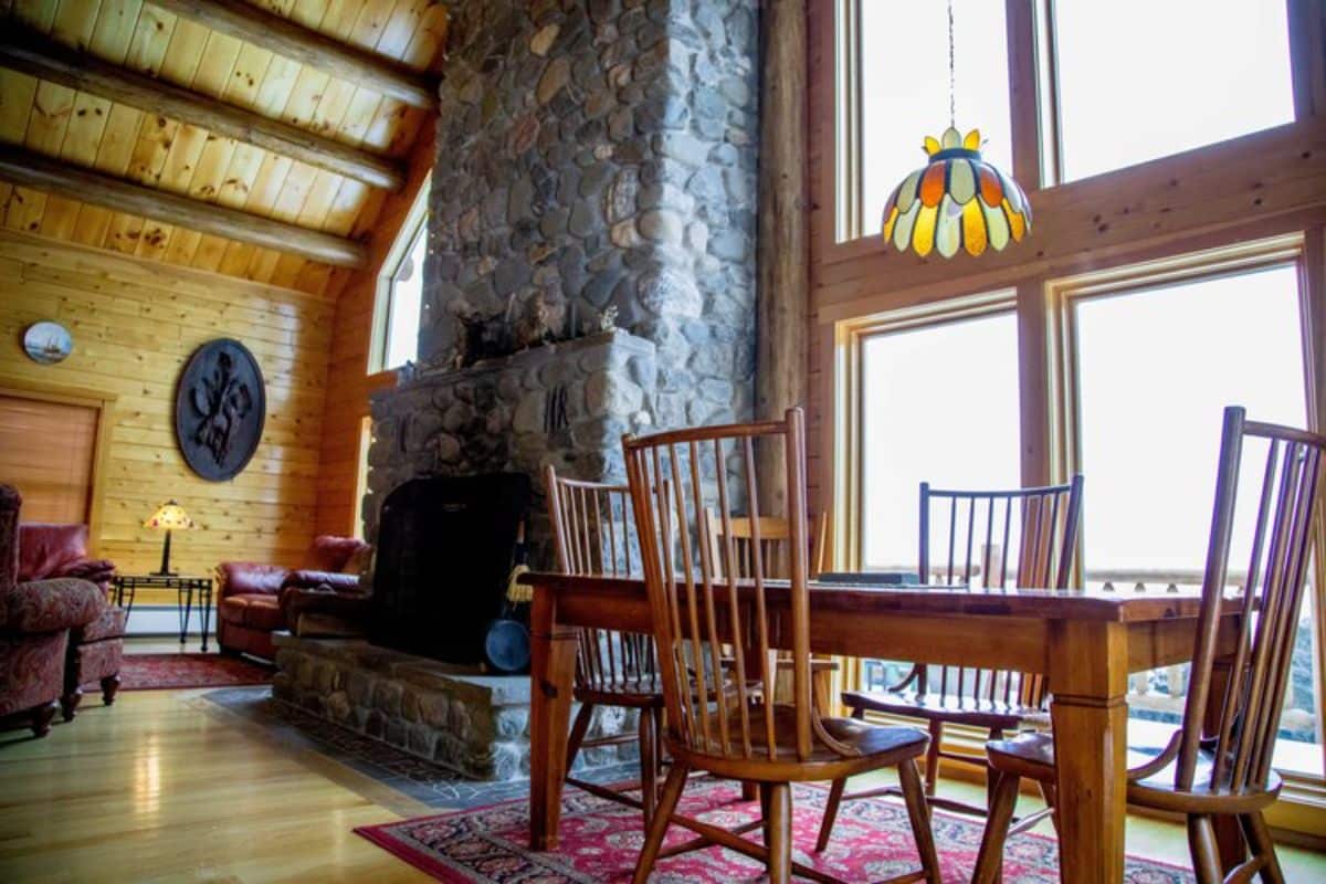 wood table in foreground of cabin dining space