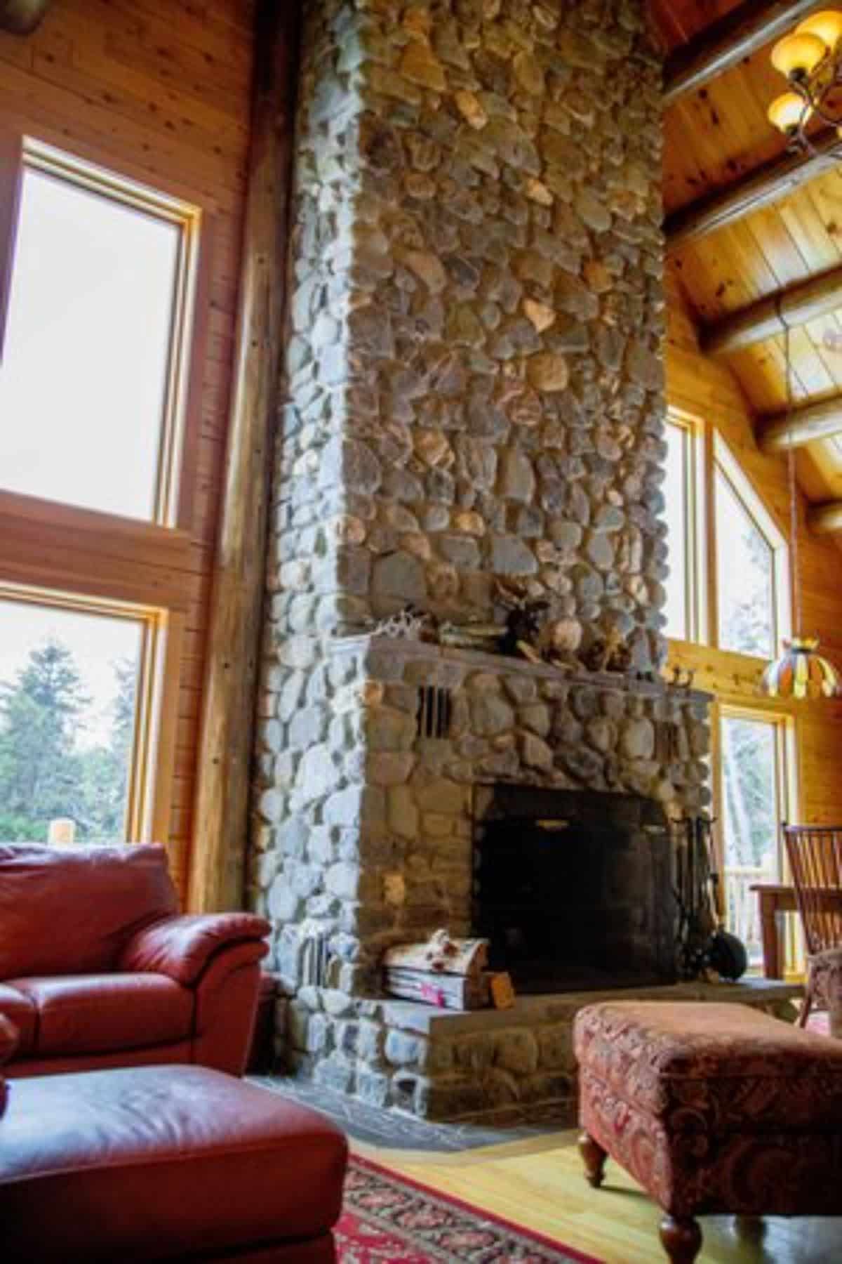 stone chimney above fireplace in main great room of cbain