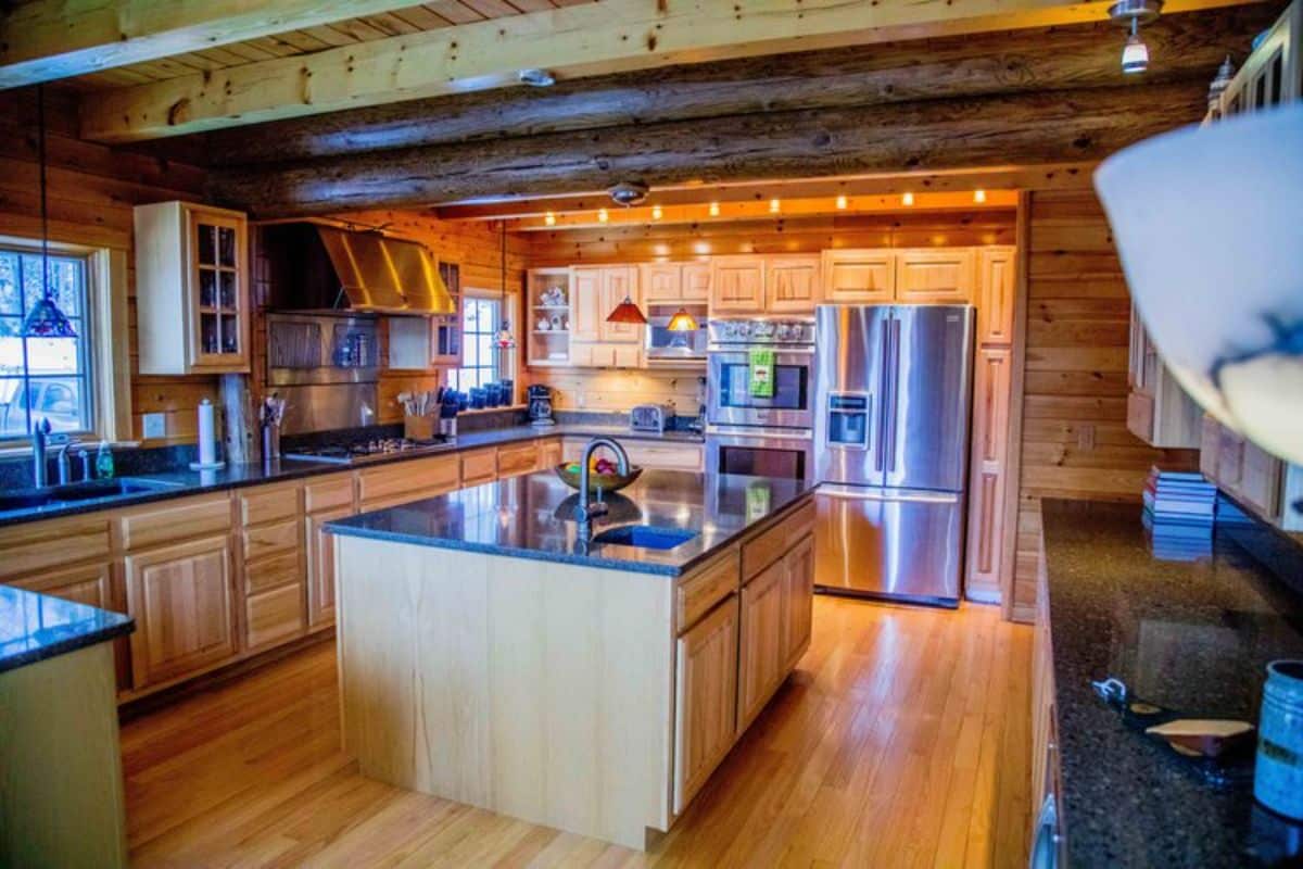 island in middle of kitchen with stainless steel appliances