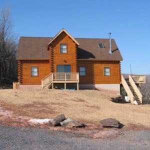 red brown siding on cabin on hill