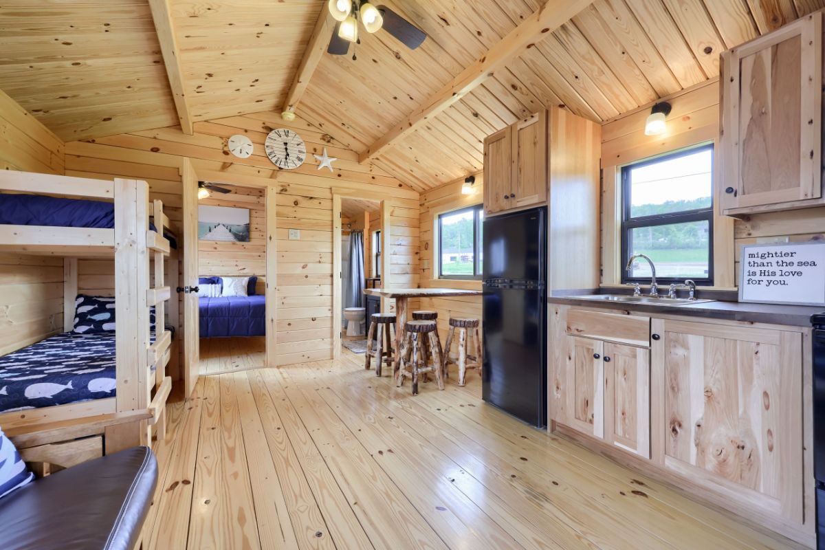 open living space with kitchen on right and bunks on left