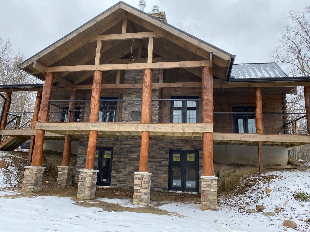 covered porches on the back of large cabin