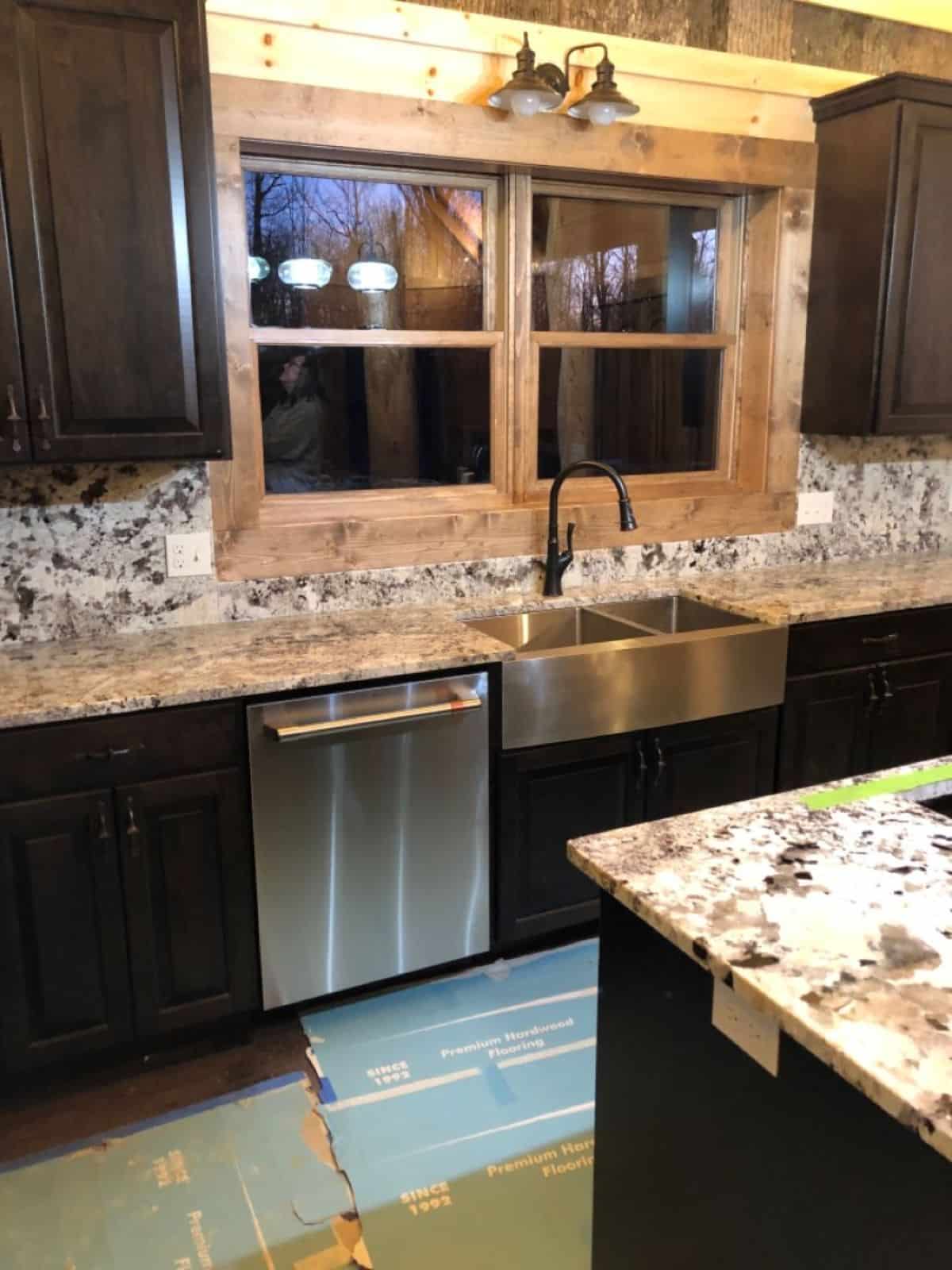 dark wood cabinets in kitchen with granite countertops