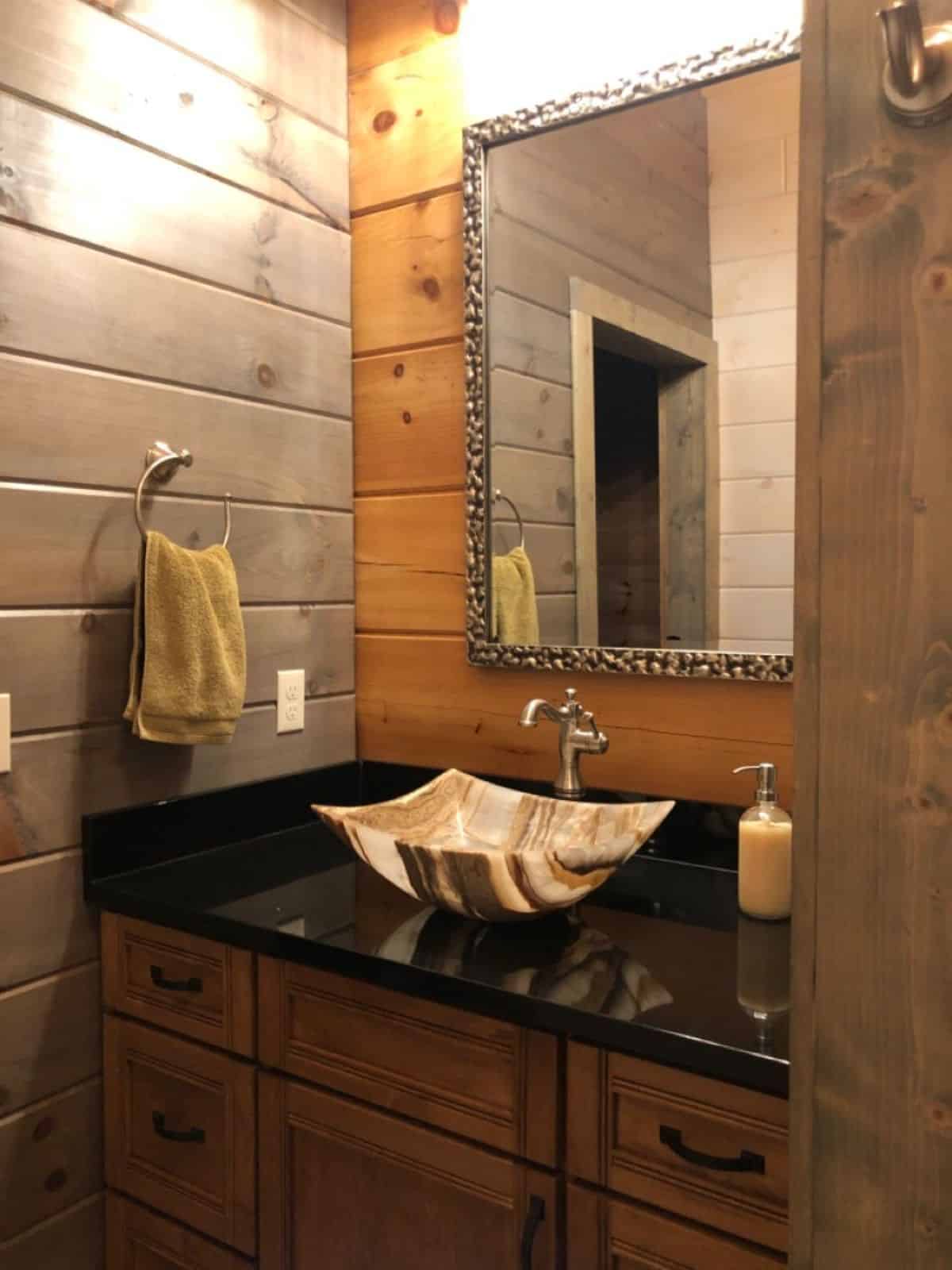 white bowl sink in bathroom on dark countertop