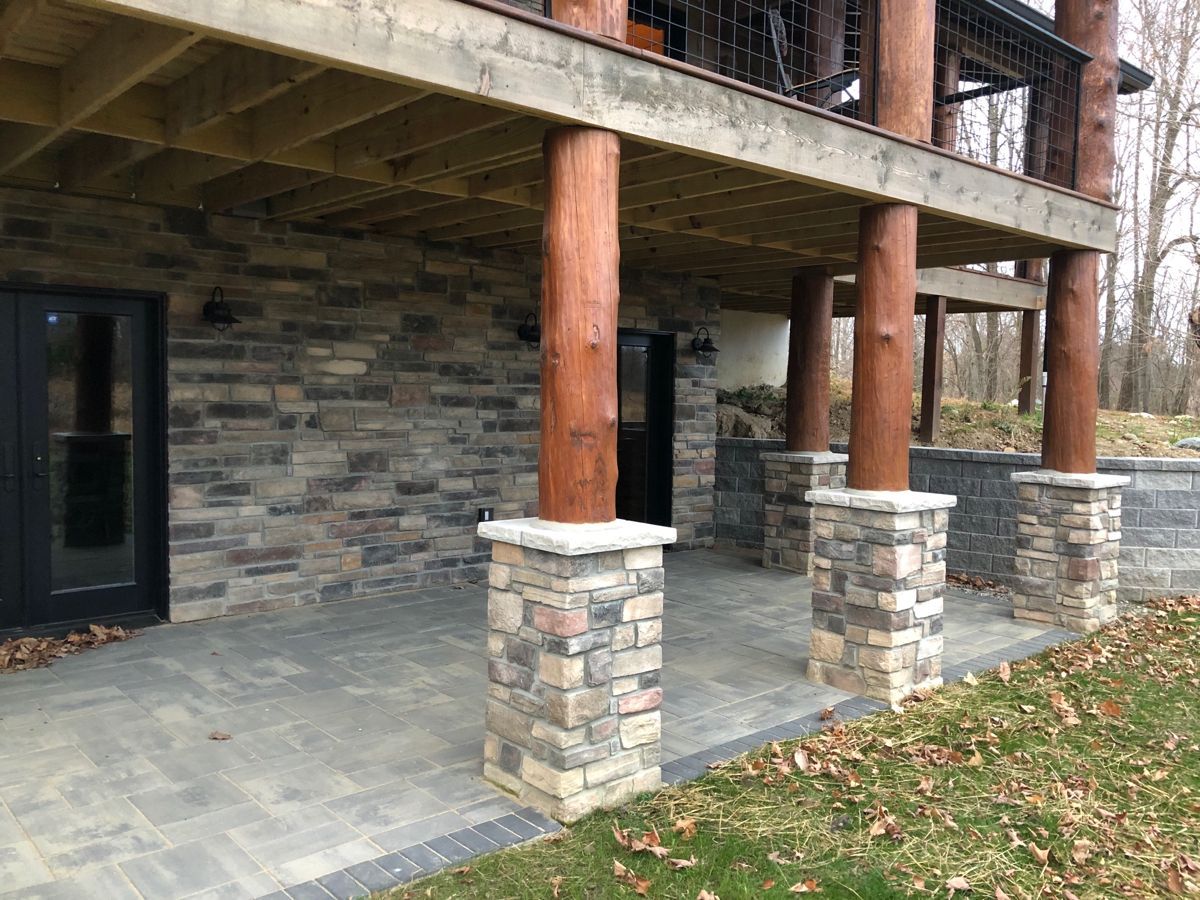 stone base around columns of porch on cabin