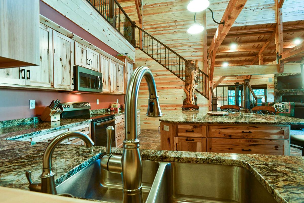 deep stainless steel sink with wood cabinets on left