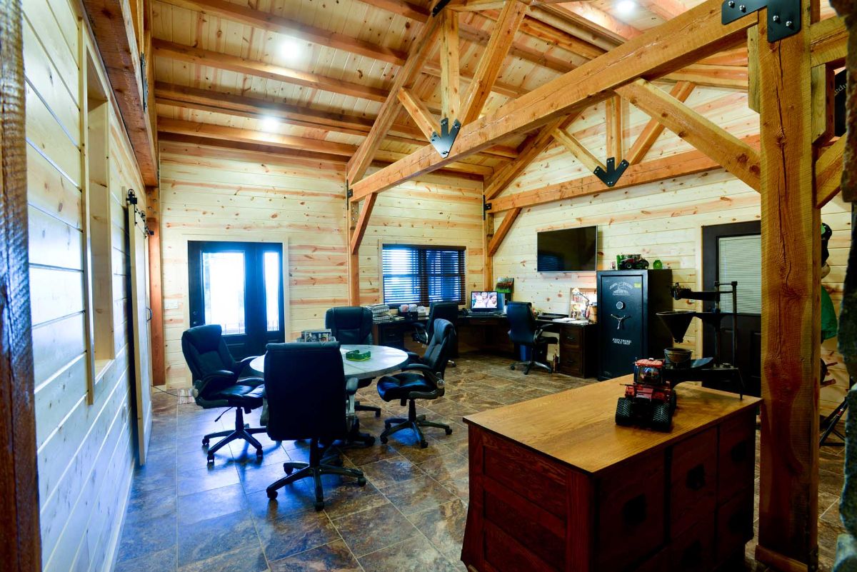 home office with exposed beam ceiling and black office furniture