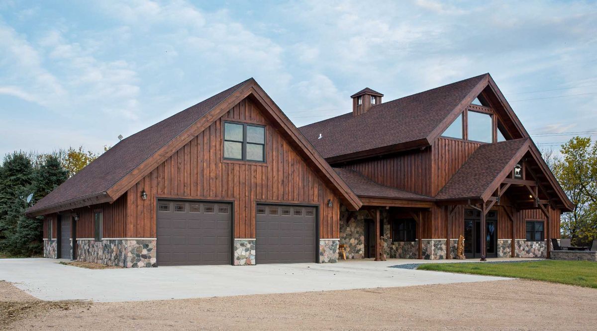 brown wood exterior on cabin with 2 car garage on end