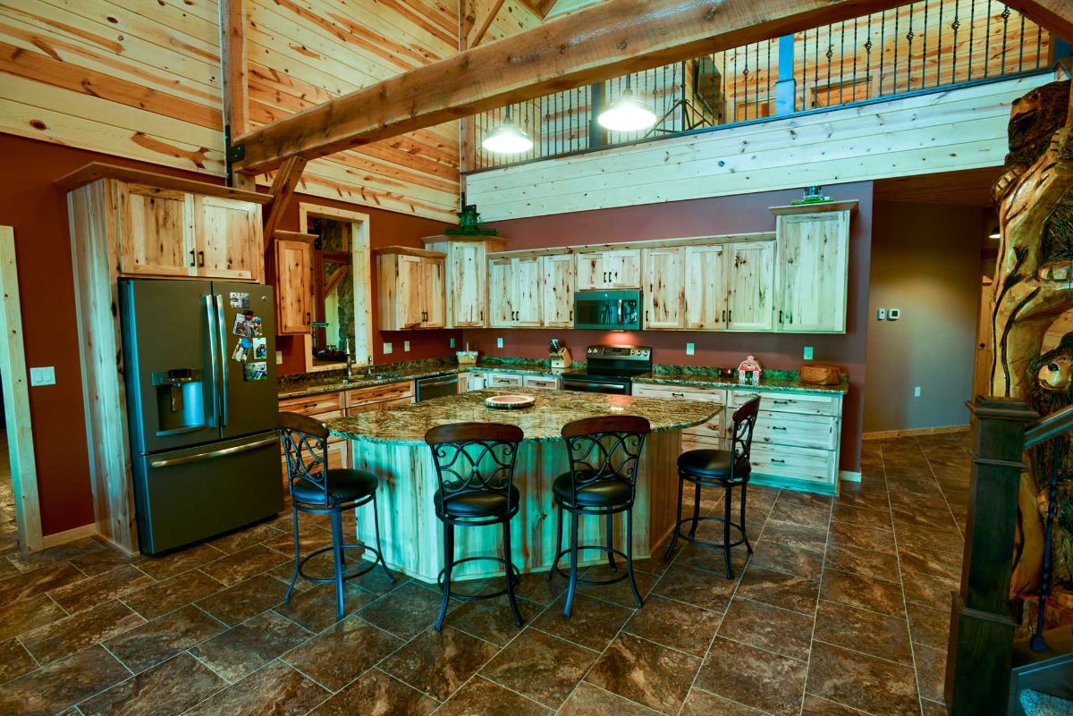 high backed black chairs around island in kitchen