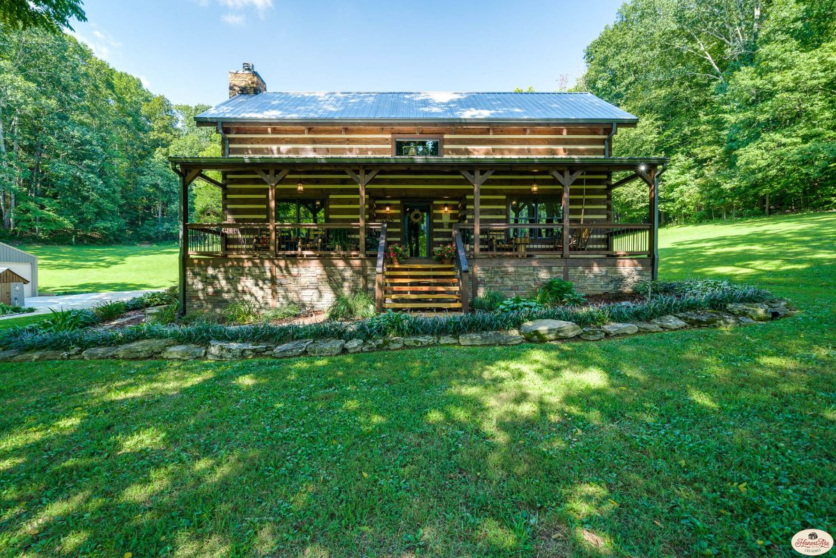 front of log cabin with covered porch