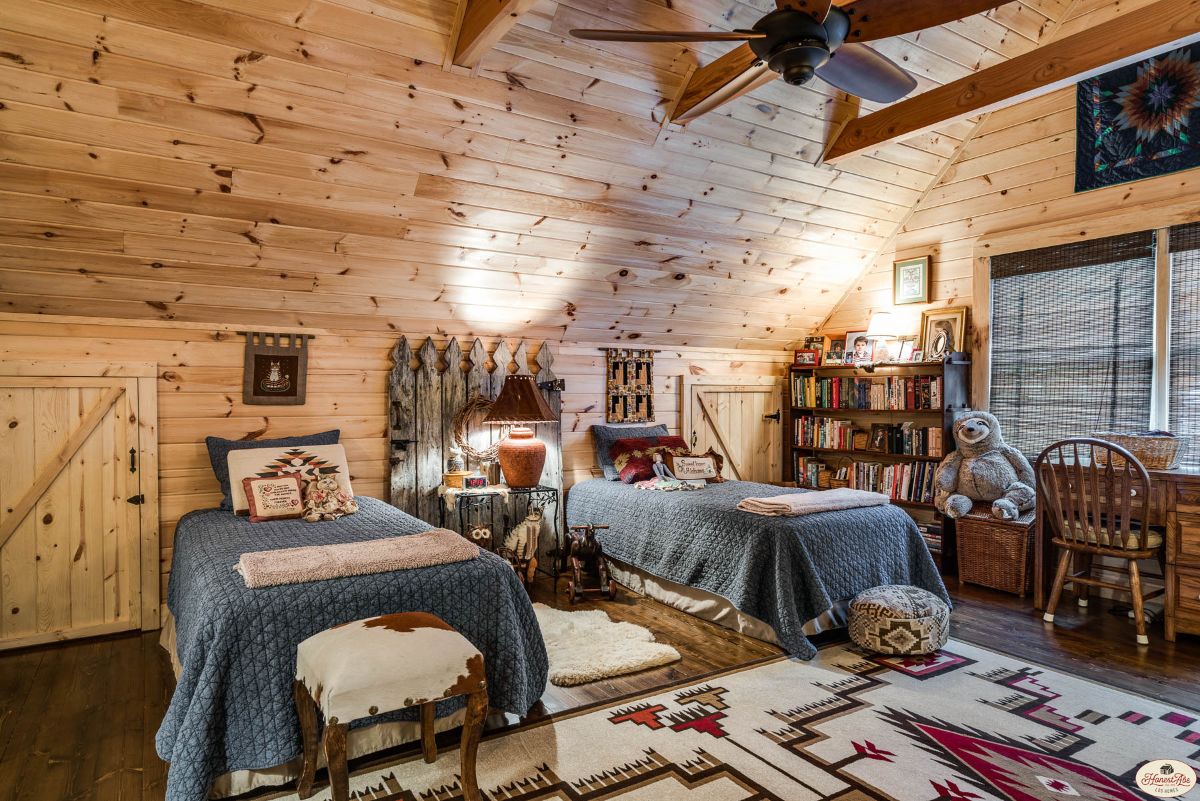 two twin beds against wall in loft of cabin